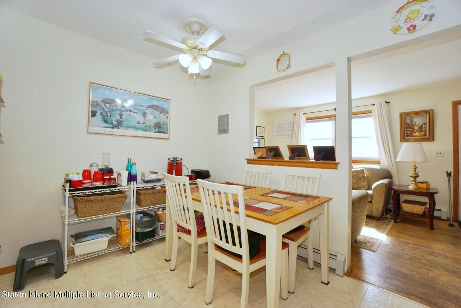 563 Mill Road Staten Island, NY 10306 - Photo 19 of 32 a view of a dining room with furniture and wooden floor