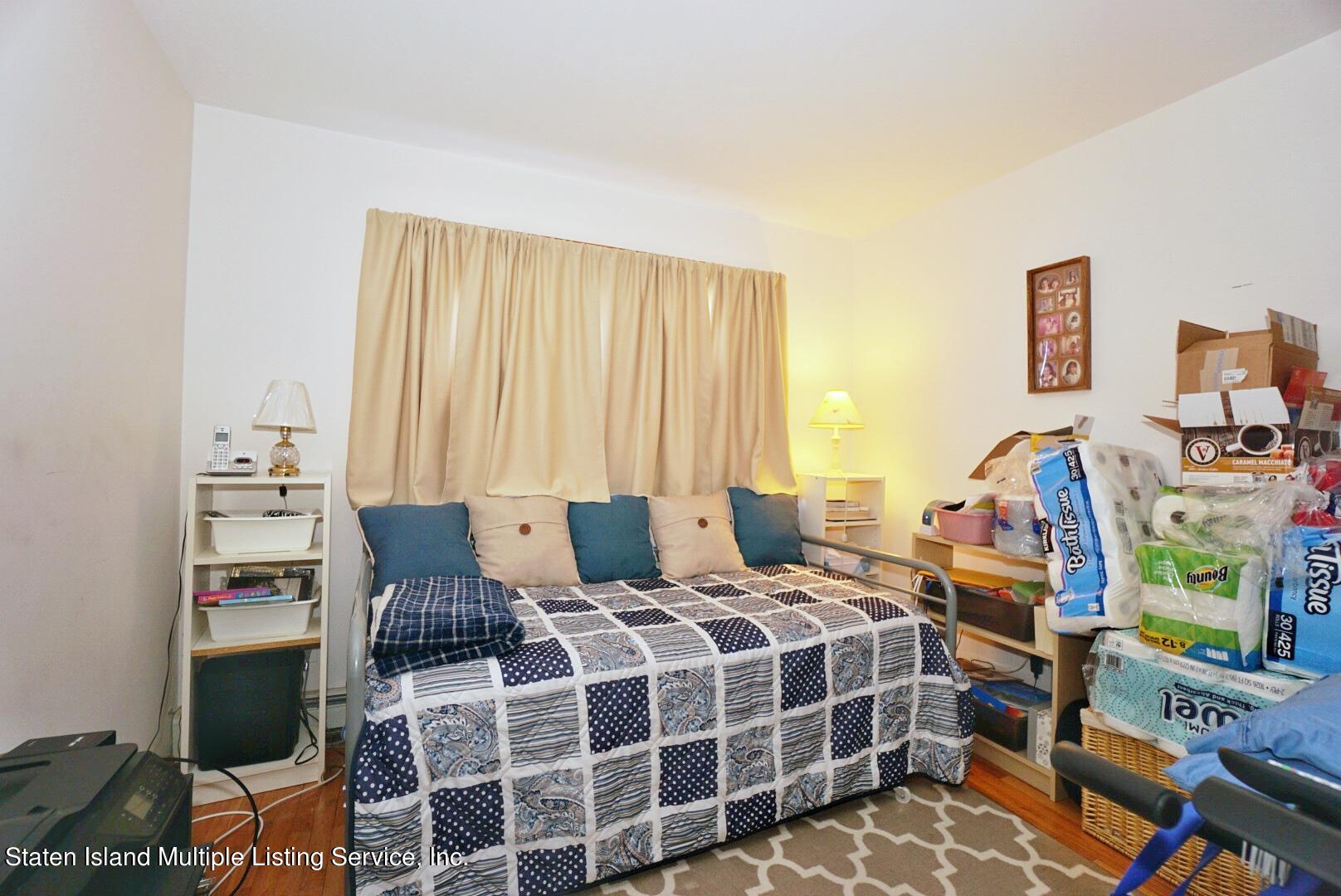 563 Mill Road Staten Island, NY 10306 - Photo 22 of 32 a bedroom with a bed and a window