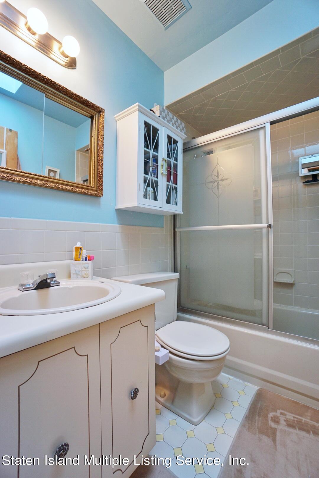 563 Mill Road Staten Island, NY 10306 - Photo 23 of 32 a bathroom with a sink toilet and shower