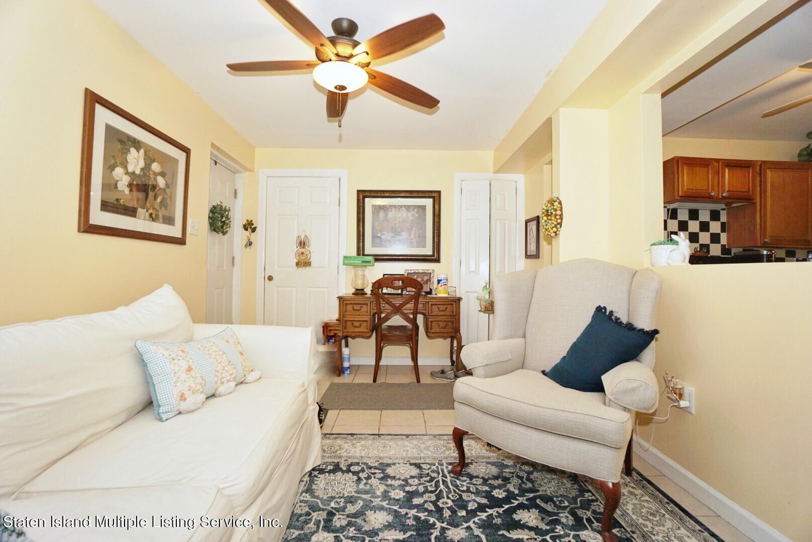 563 Mill Road Staten Island, NY 10306 - Photo 24 of 32 a living room with furniture and a rug