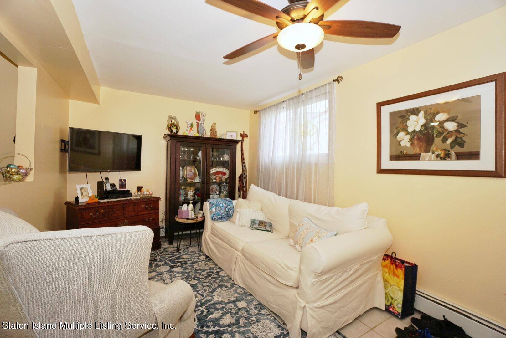 563 Mill Road Staten Island, NY 10306 - Photo 25 of 32 a living room with furniture a flat screen tv and a window