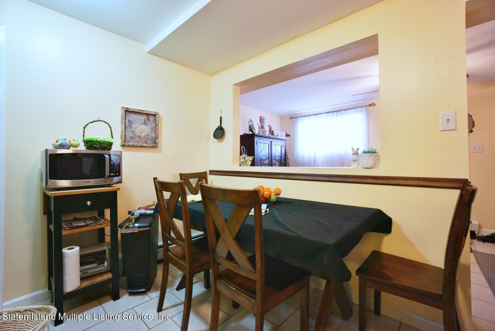 563 Mill Road Staten Island, NY 10306 - Photo 26 of 32 a view of a dining room with furniture and wooden floor