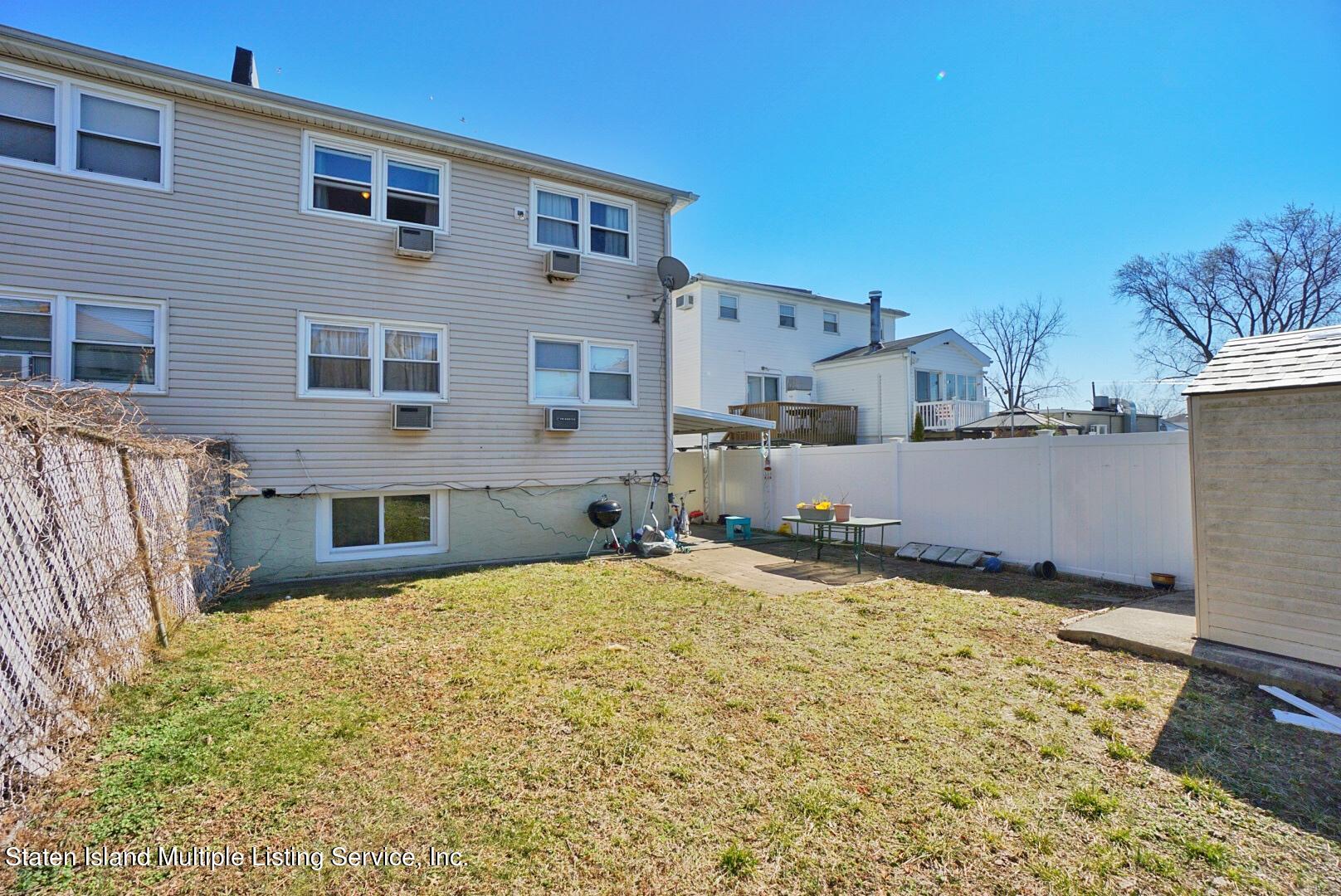563 Mill Road Staten Island, NY 10306 - Photo 30 of 32 a view of a house with snow on the background