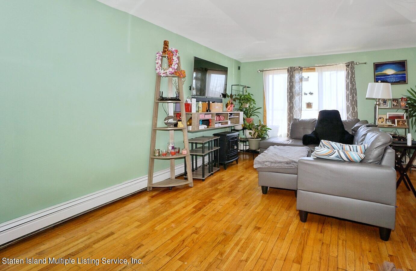 563 Mill Road Staten Island, NY 10306 - Photo 3 of 32 a living room with furniture and a wooden floor