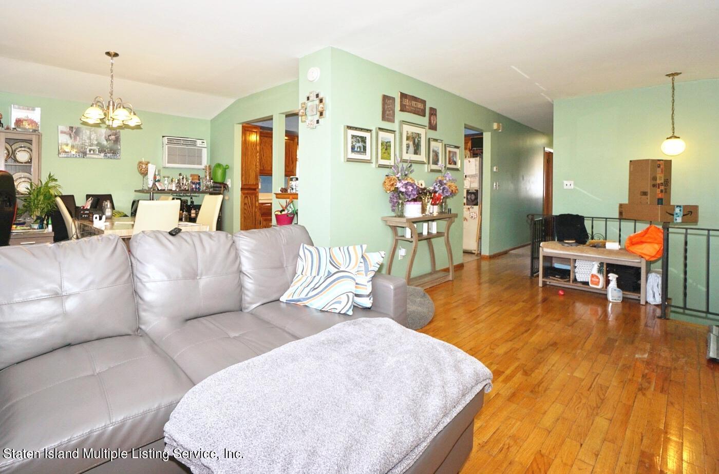 563 Mill Road Staten Island, NY 10306 - Photo 4 of 32 a living room with furniture and wooden floor
