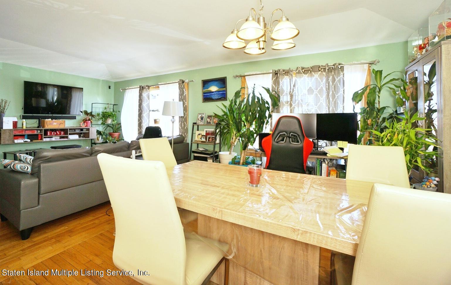 563 Mill Road Staten Island, NY 10306 - Photo 5 of 32 a view of a dining room with furniture and a flat screen tv