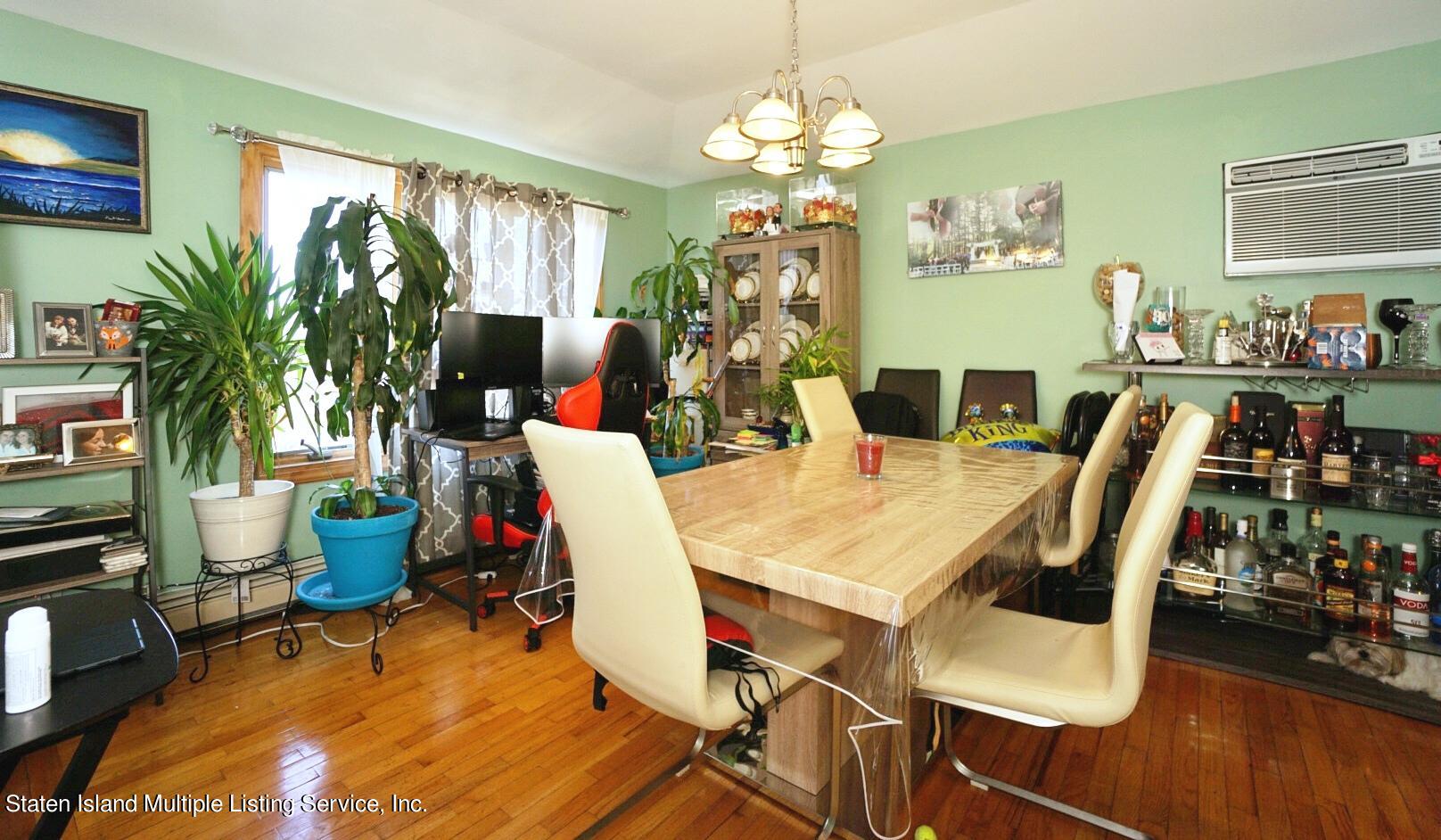 563 Mill Road Staten Island, NY 10306 - Photo 6 of 32 a view of a dining room with furniture window and wooden floor