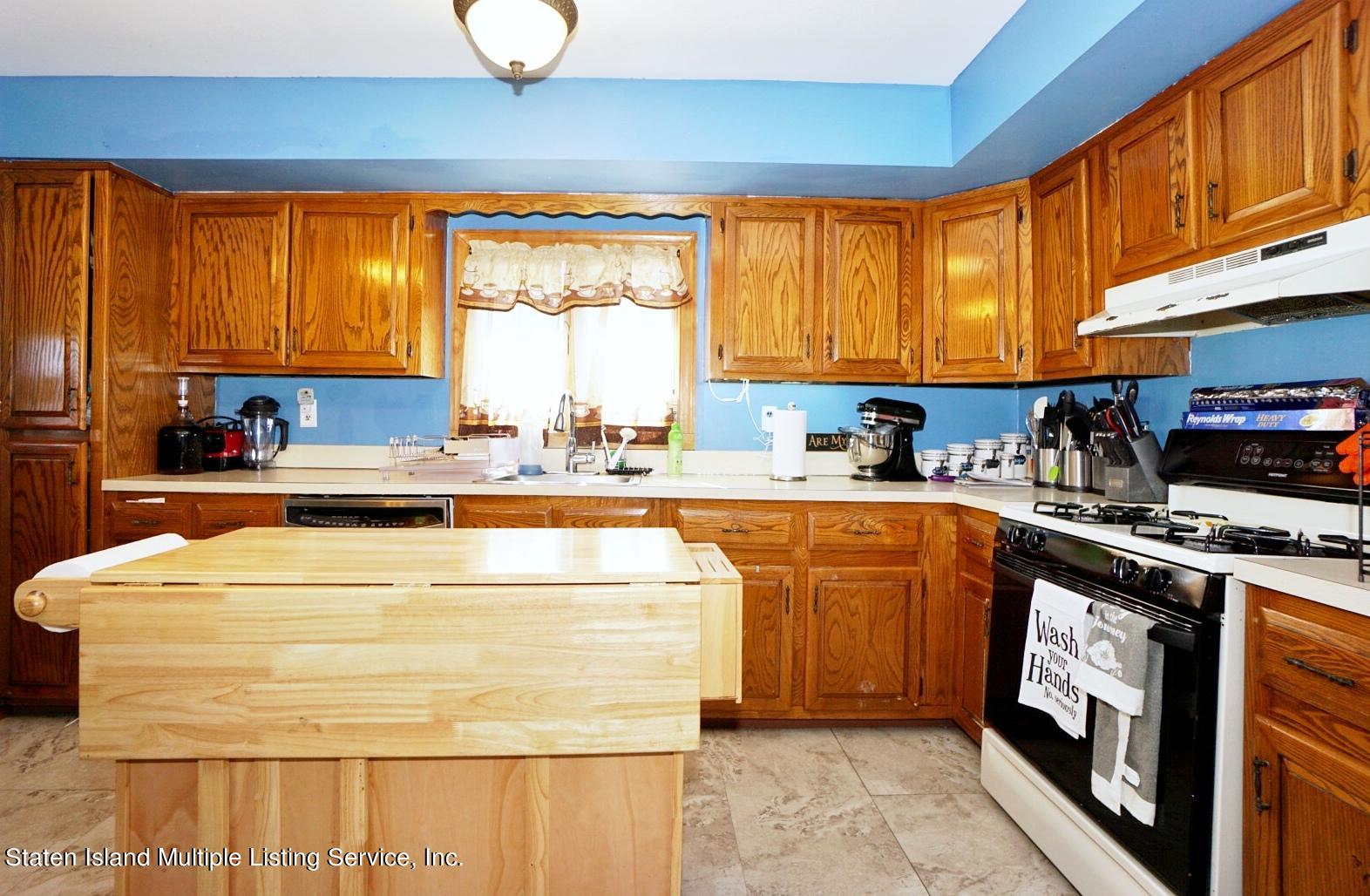 563 Mill Road Staten Island, NY 10306 - Photo 7 of 32 a kitchen with stainless steel appliances granite countertop a sink a stove and a refrigerator