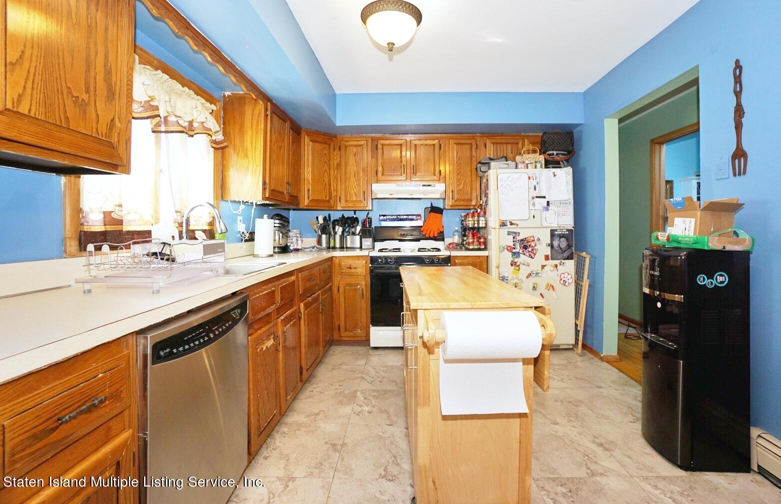 563 Mill Road Staten Island, NY 10306 - Photo 8 of 32 a large kitchen with kitchen island a large counter top space a sink a window and stainless steel appliances
