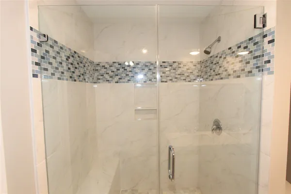 a bathroom with a shower a sink and a mirror