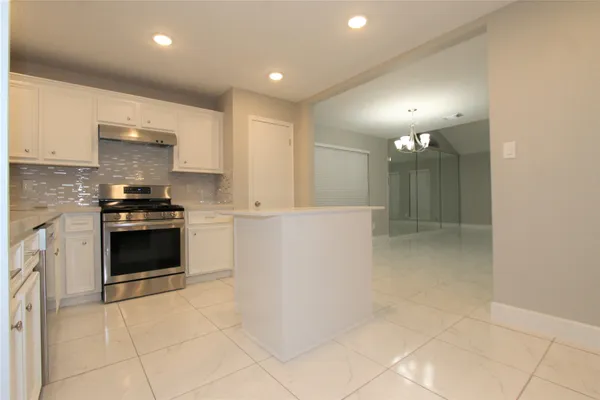 a view of a livingroom with kitchen and fireplace