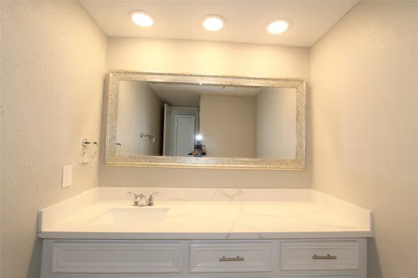 a bathroom with a window and mirror
