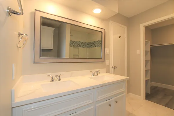 a white toilet sitting next to a white wall