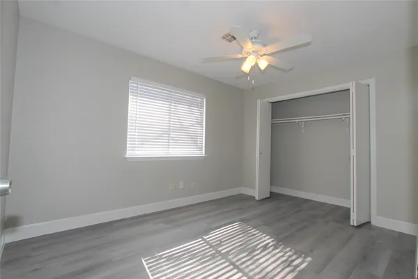 a view of a room window and wooden floor