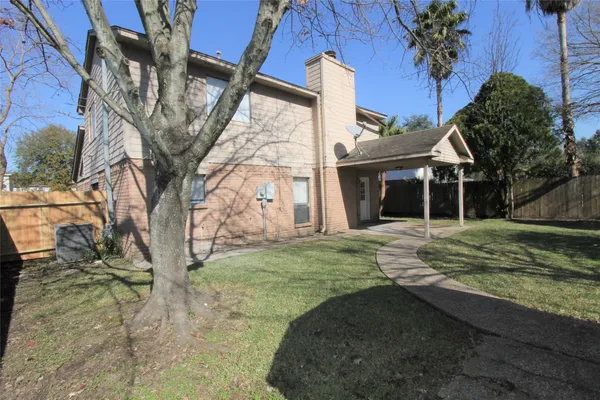 a backyard of a house with a basket ball court