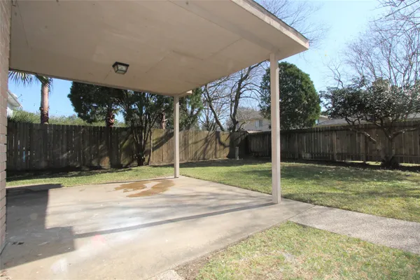 a view of house with backyard