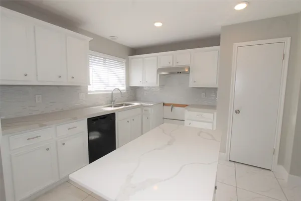 a kitchen with a sink and cabinets