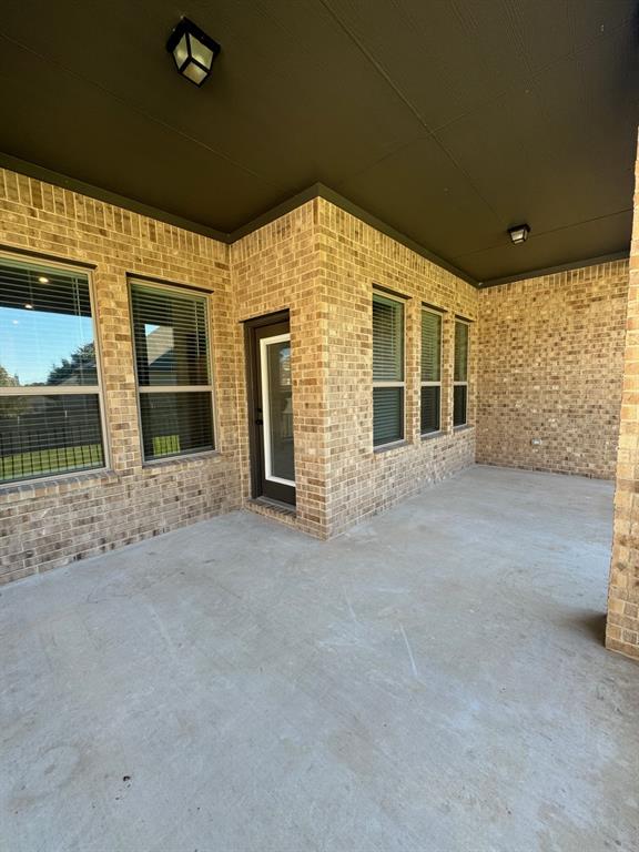 3833 Mercer Road Georgetown, TX 78628 - Photo 22 of 25 A spacious covered patio invites relaxation and outdoor enjoyment.
