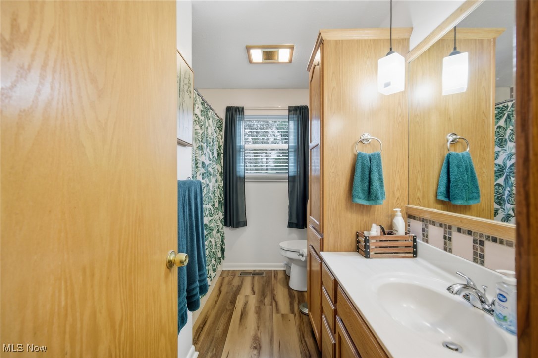 1788 Ashby Ridge Road Parkersburg, WV 26104 - Photo 23 of 46 Bathroom featuring light wood-style floors, vanity, and curtained shower