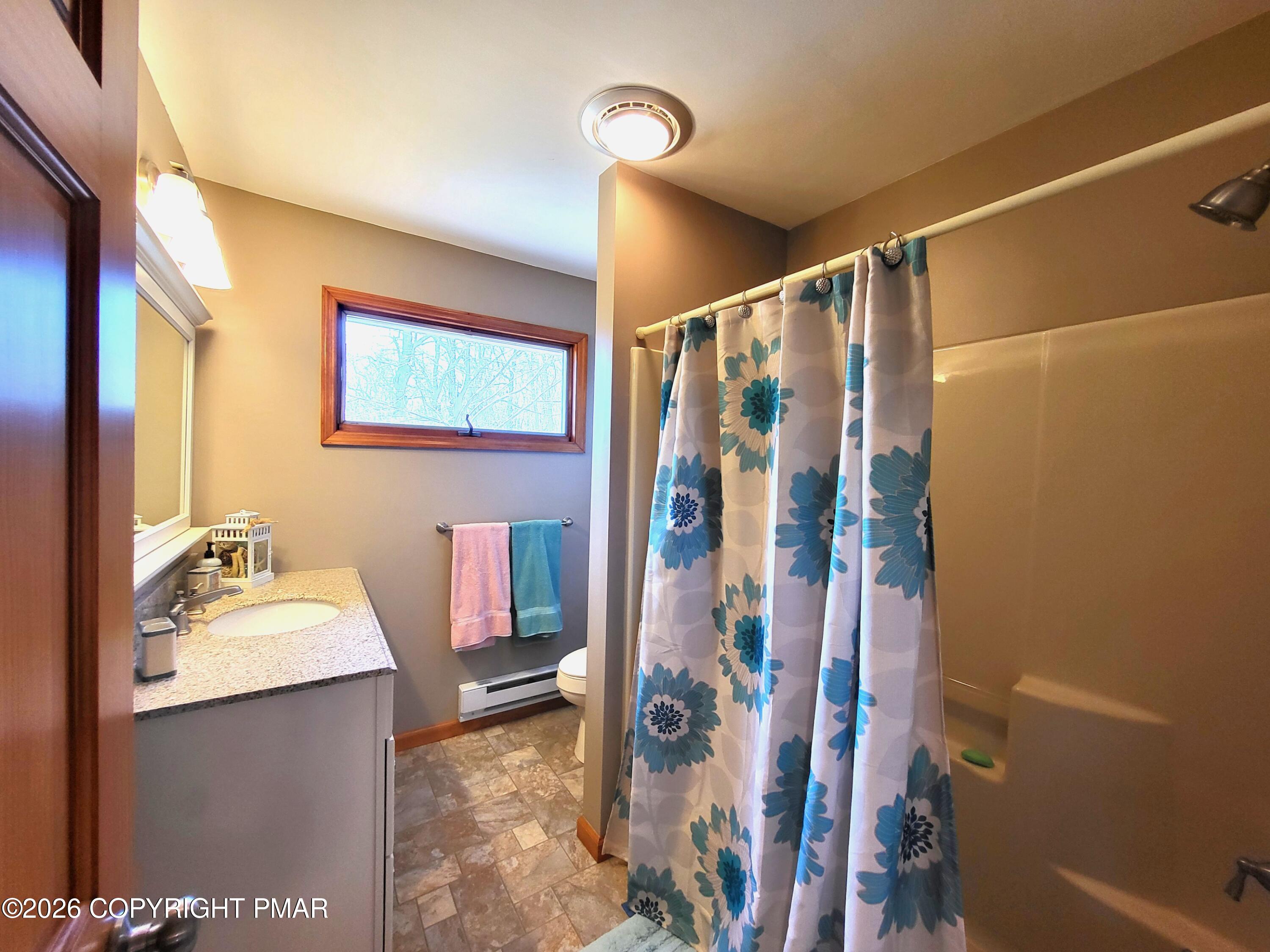 155 Clifton Drive Bushkill, PA 18324 - Photo 22 of 75 a bathroom with a sink vanity mirror and shower
