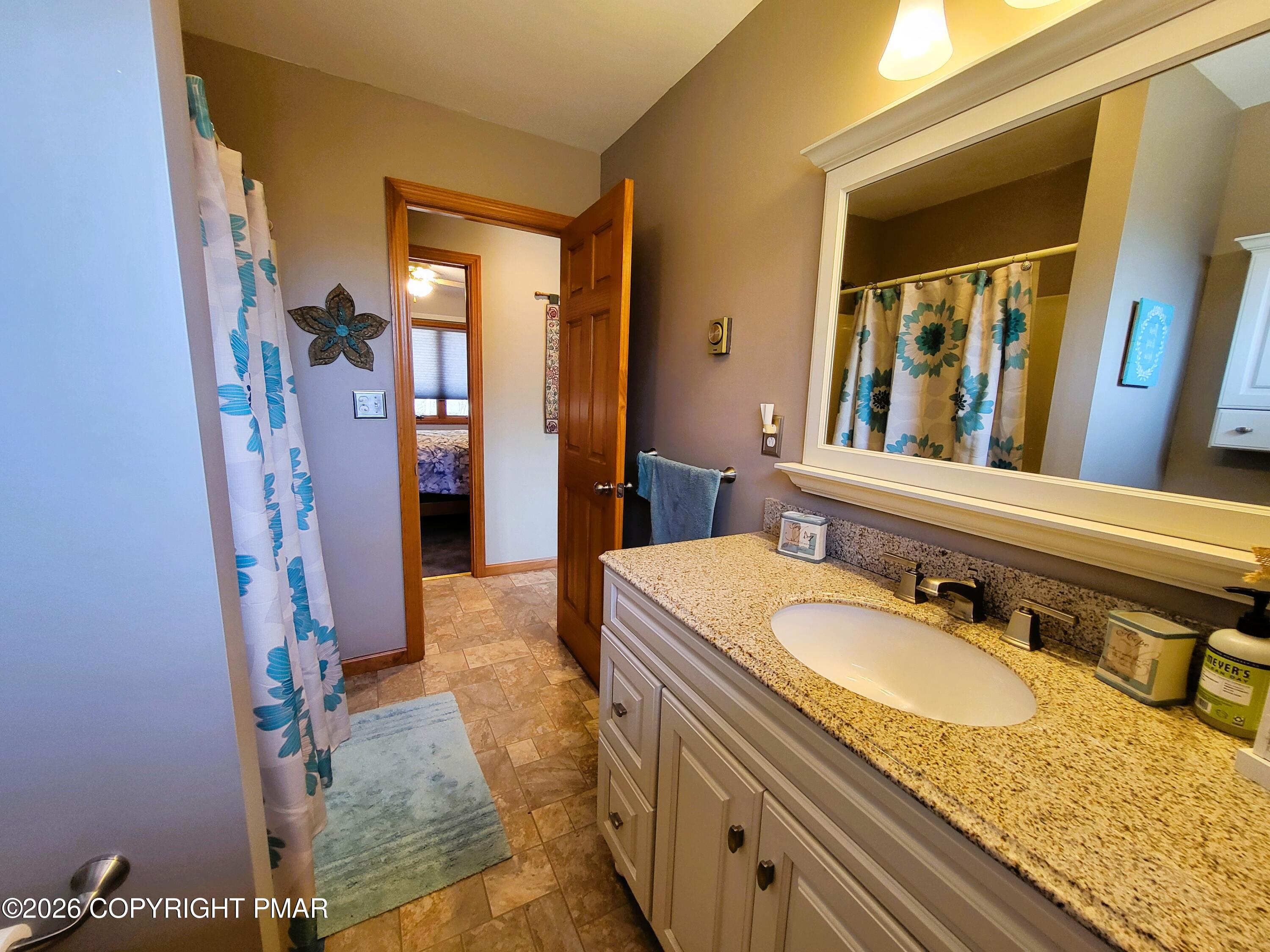 155 Clifton Drive Bushkill, PA 18324 - Photo 23 of 75 a bathroom with a granite countertop sink and a mirror