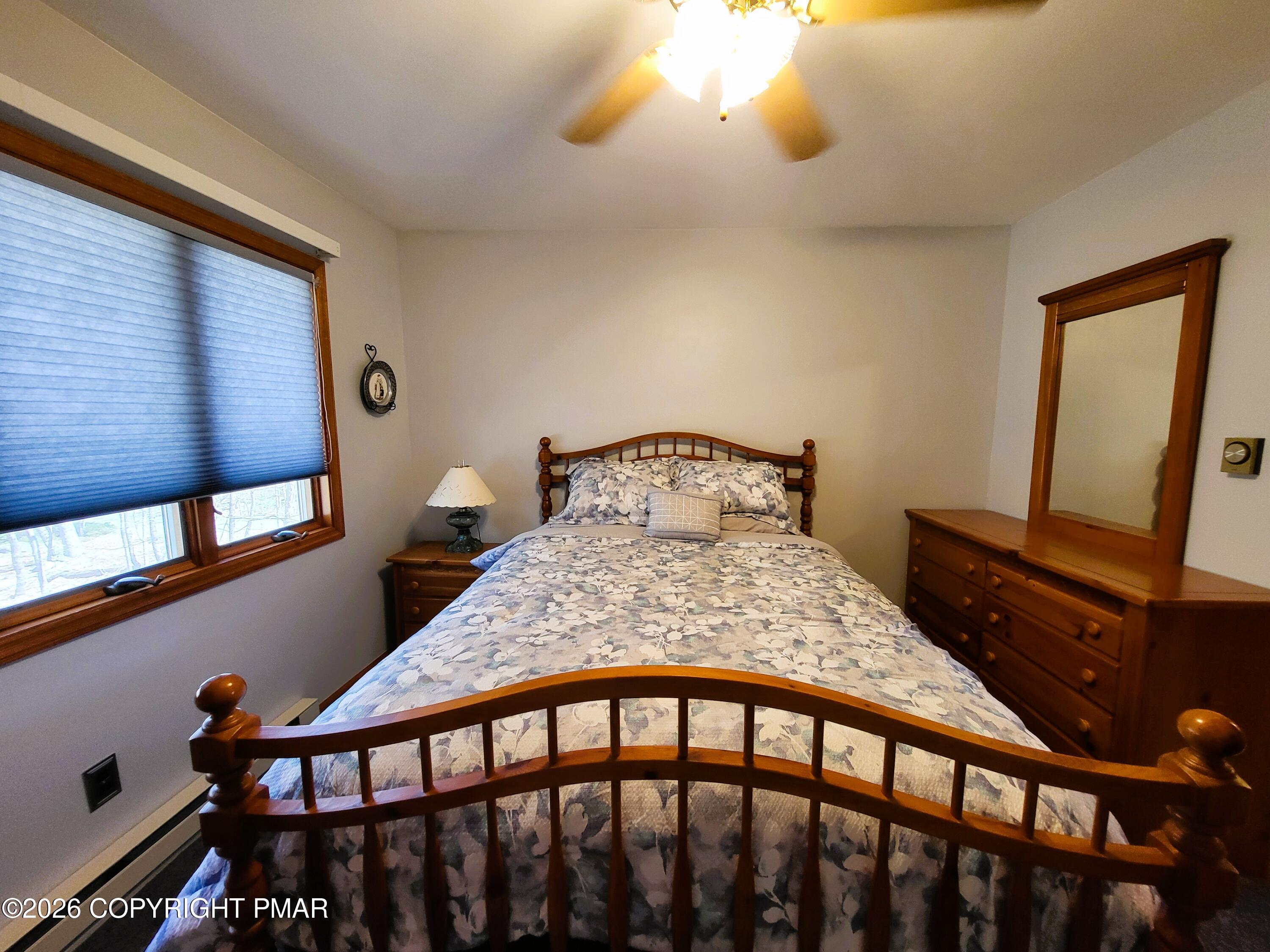 155 Clifton Drive Bushkill, PA 18324 - Photo 24 of 75 a bedroom with a bed and wooden floor