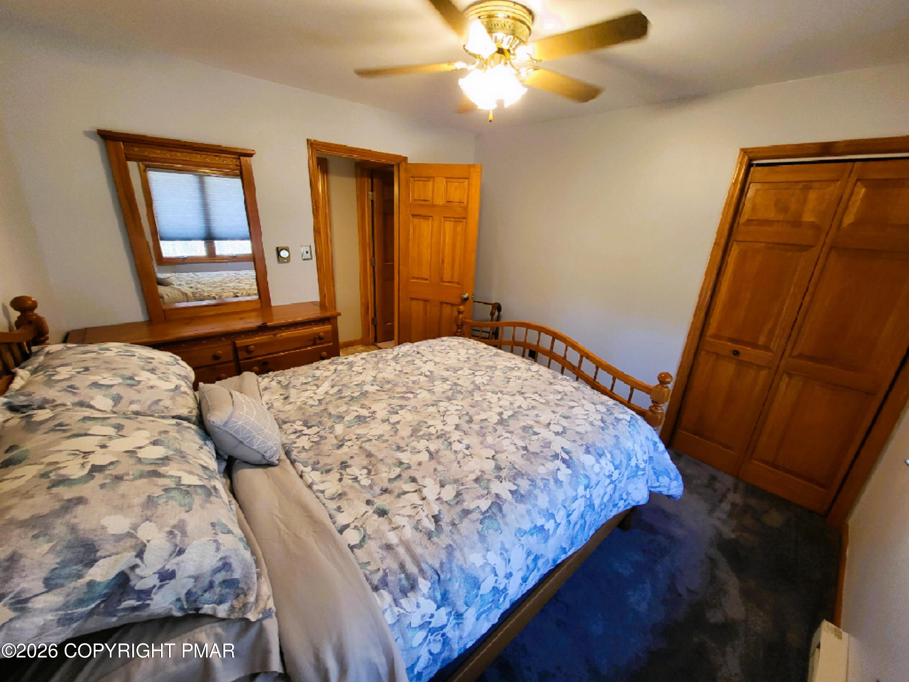 155 Clifton Drive Bushkill, PA 18324 - Photo 25 of 75 a bedroom with a bed and a mirror on dresser