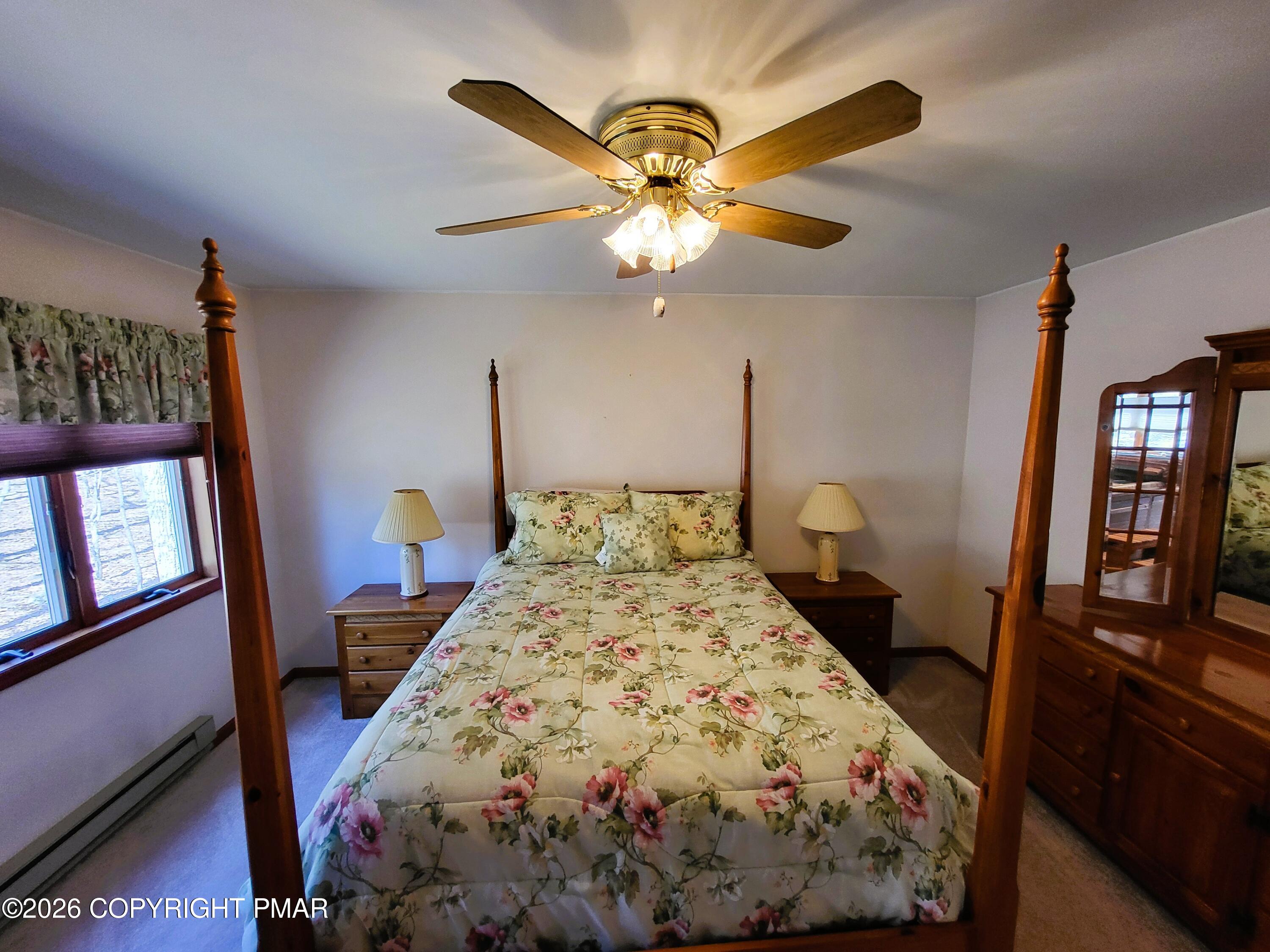 155 Clifton Drive Bushkill, PA 18324 - Photo 27 of 75 a bed sitting in a bedroom next to a window