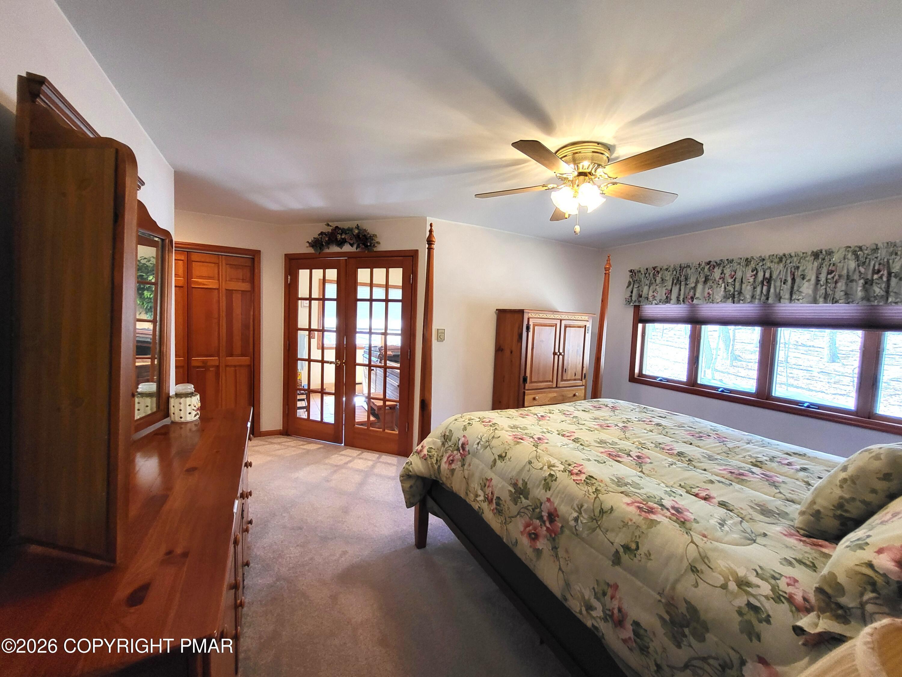155 Clifton Drive Bushkill, PA 18324 - Photo 29 of 75 a spacious bedroom with a large bed and a chandelier