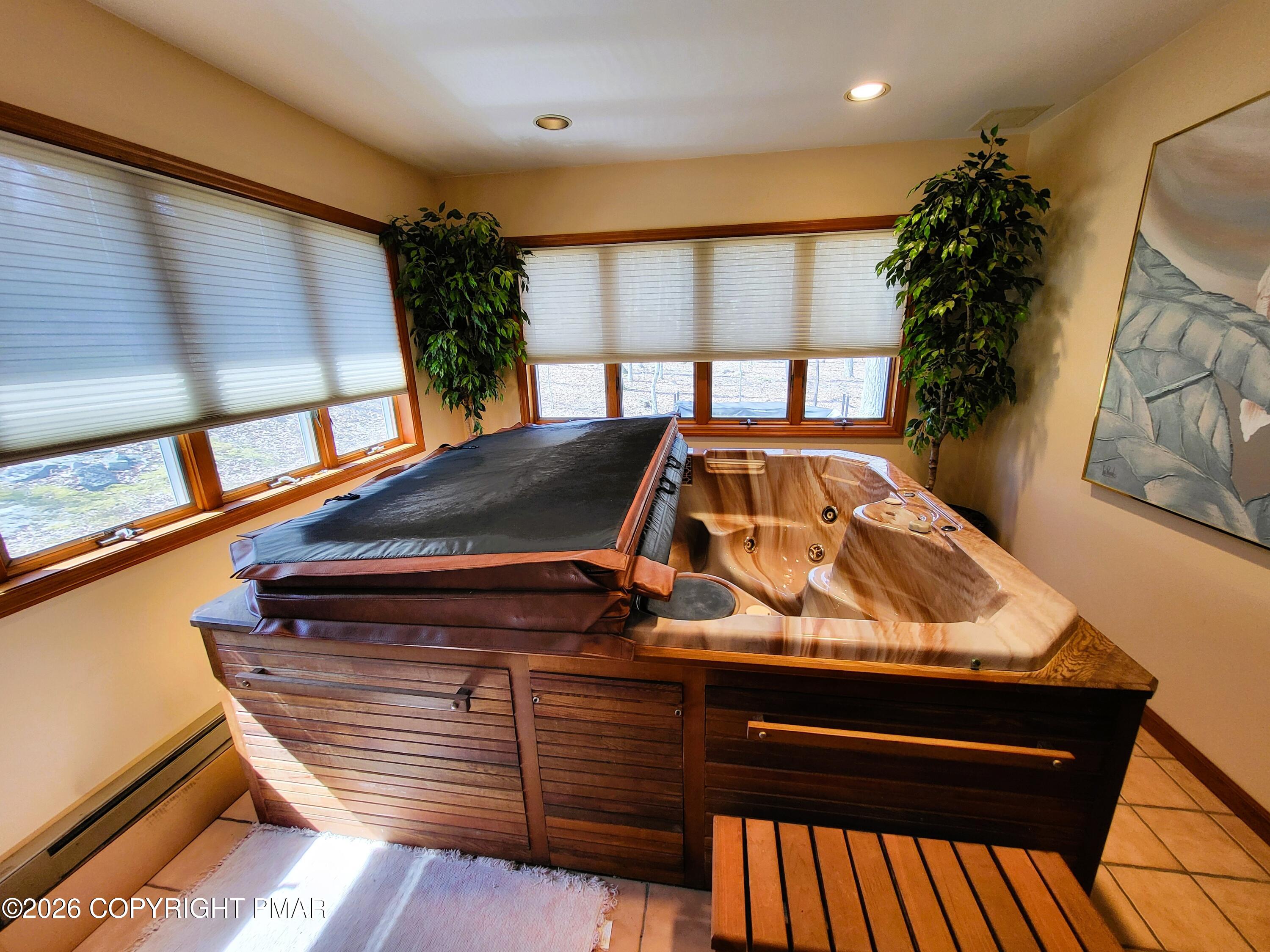 155 Clifton Drive Bushkill, PA 18324 - Photo 30 of 75 a view of a balcony with furniture and floor to ceiling window