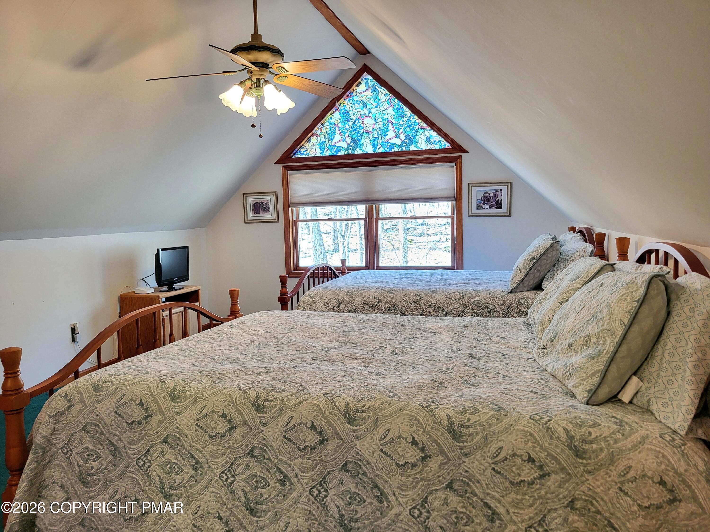 155 Clifton Drive Bushkill, PA 18324 - Photo 37 of 75 a bedroom with a bed and a chandelier