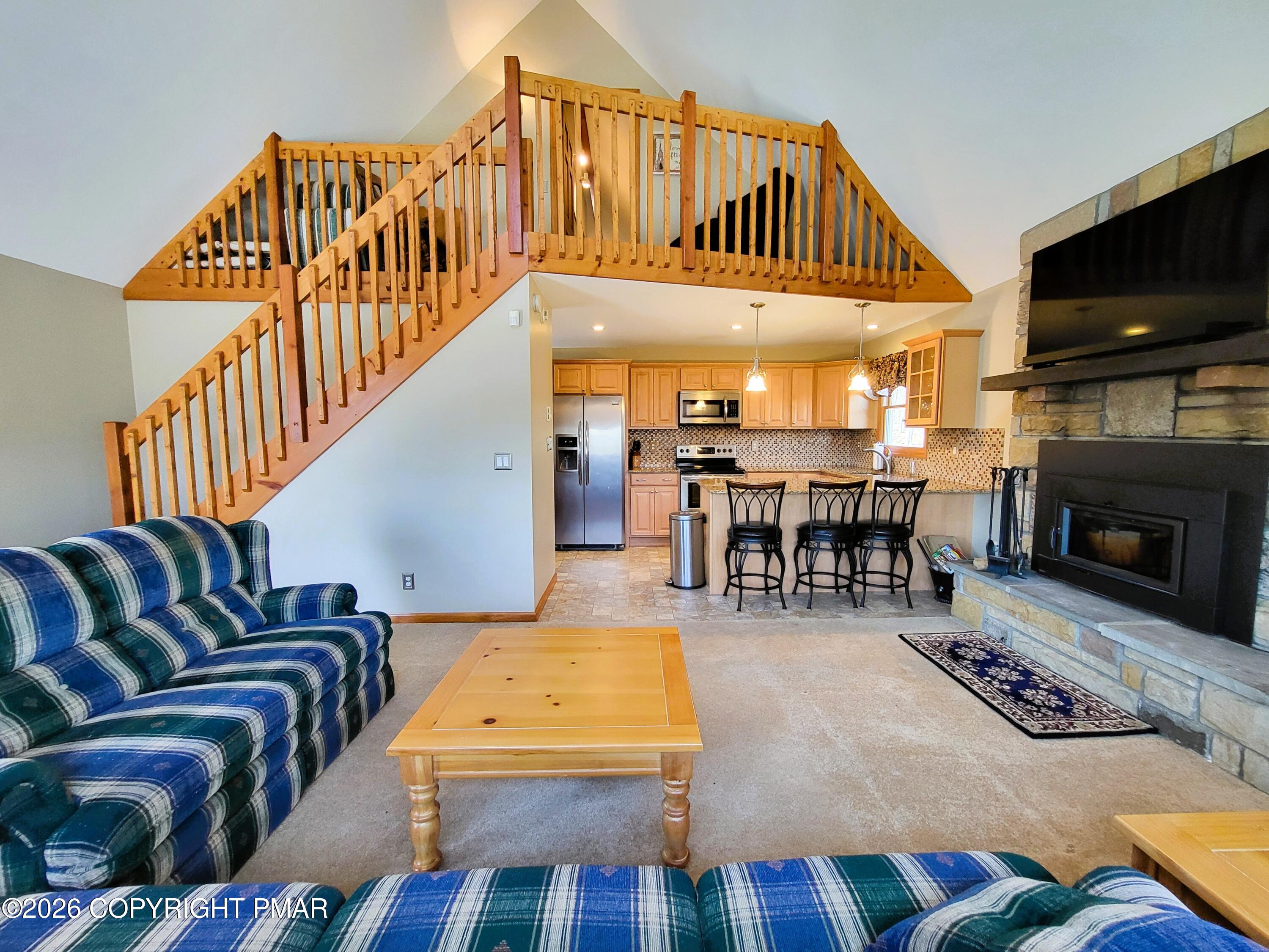 155 Clifton Drive Bushkill, PA 18324 - Photo 5 of 75 a living room with furniture a flat screen tv and a fireplace