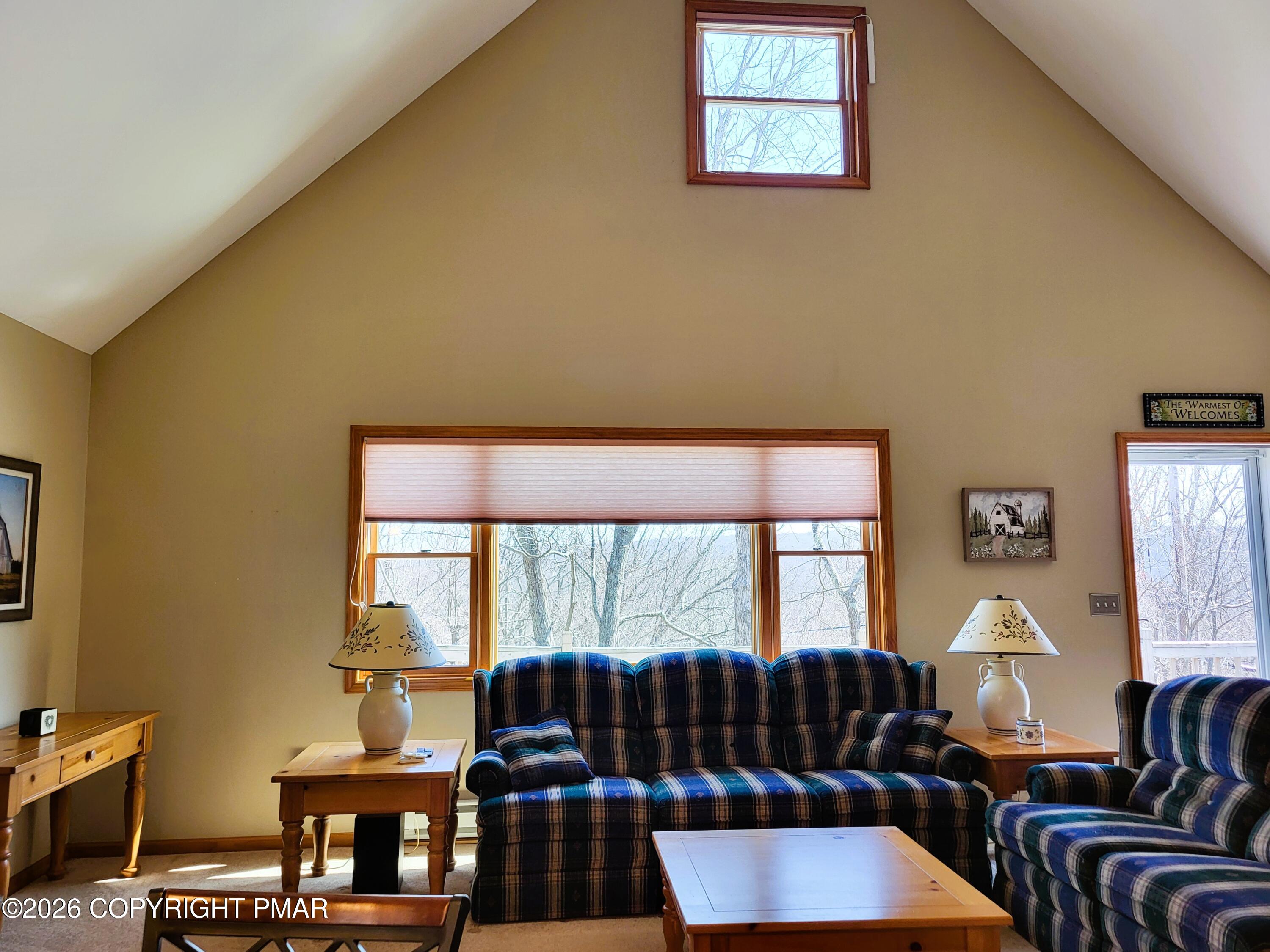 155 Clifton Drive Bushkill, PA 18324 - Photo 9 of 75 a living room with furniture and a floor to ceiling window