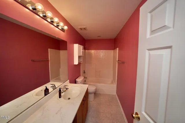 a bathroom with a double vanity sink and mirror