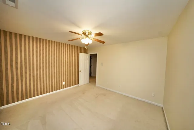 a view of an empty room with a chandelier