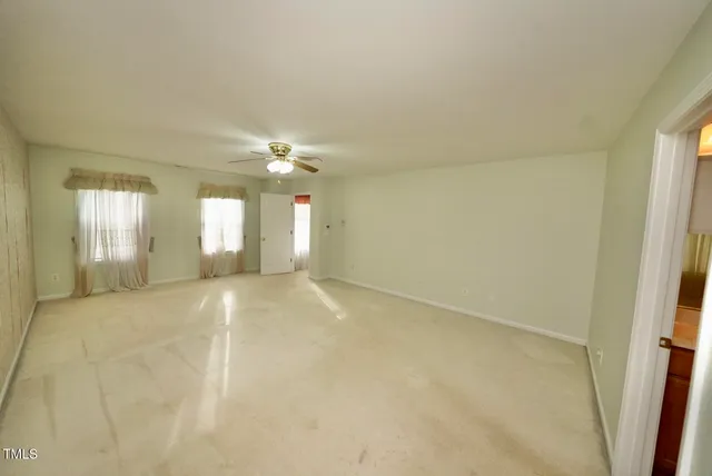 an empty room with windows and entrance