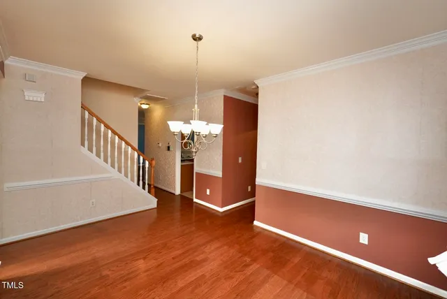 a view of a room with wooden floor