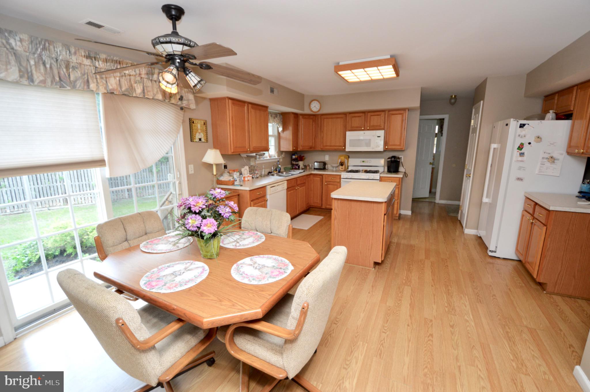 8 Toby Wells Court Delran, NJ 08075 - Photo 7 of 23 a view of a dining room and livingroom with furniture wooden floor a rug a chandelier