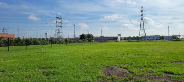 a view of a big yard with a table and chairs