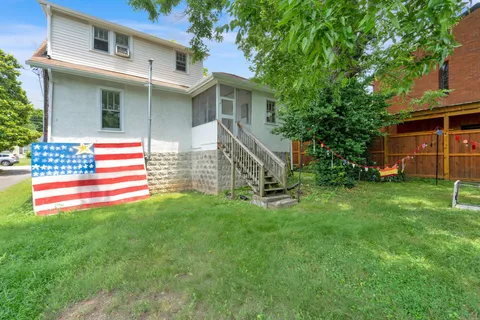 a front view of a house with a garden and yard