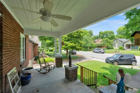 a view of a patio with couches table and chairs and potted plants