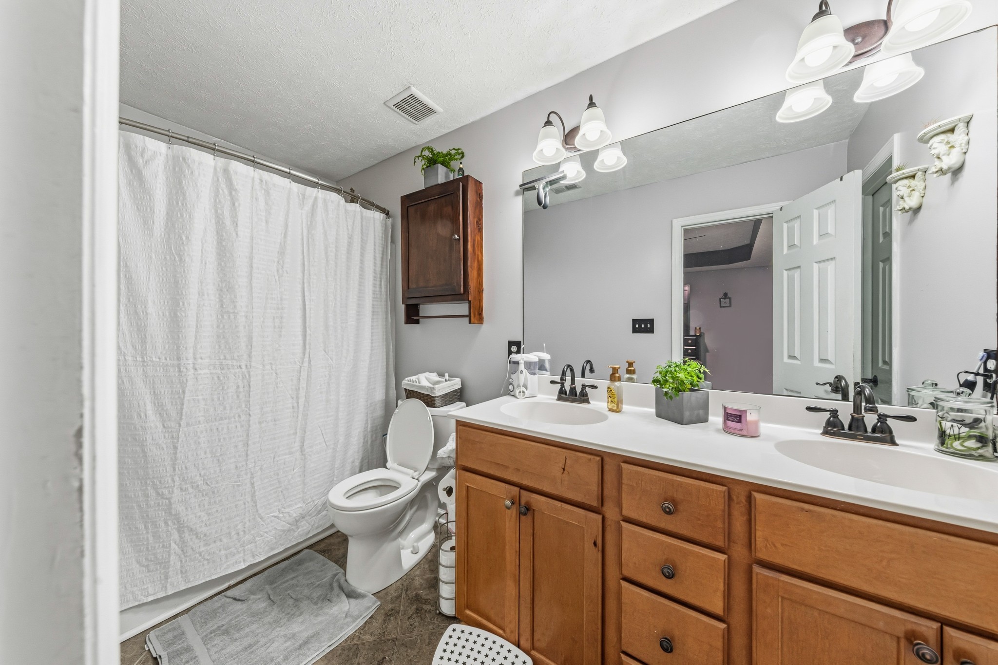 699 Puckett Road Watertown, TN 37184 - Photo 16 of 53 a spacious bathroom with a granite countertop sink a toilet and a mirror