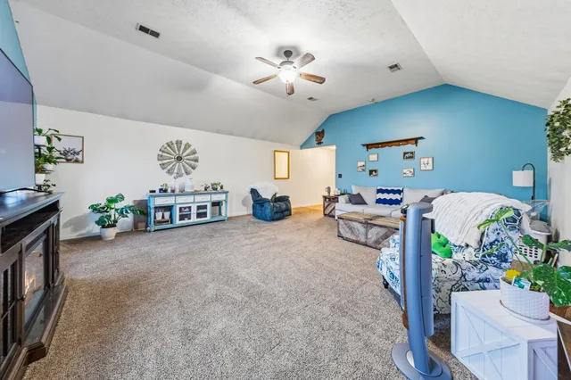 a living room with furniture and a chandelier