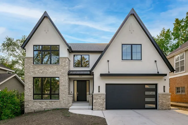 a front view of a house with garage