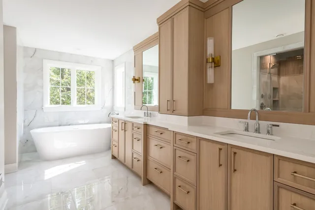 a bathroom with a granite countertop sink mirror and a bathtub