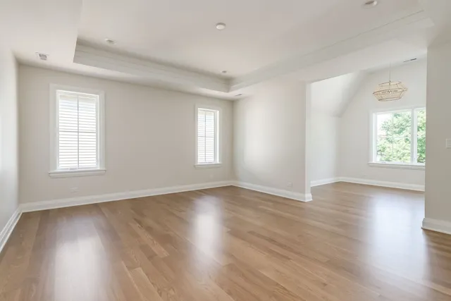 a view of an empty room and wooden floor