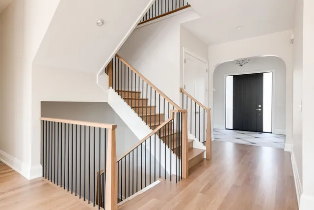 a view of a hallway with wooden floor and entryway
