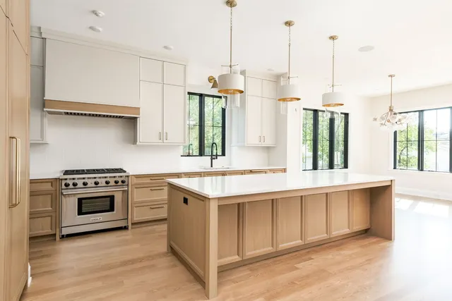 a kitchen with stainless steel appliances granite countertop a stove and a sink