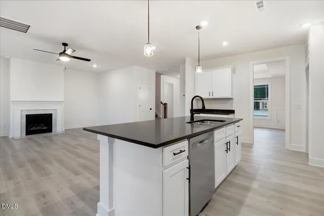 an empty room with windows and ceiling fan