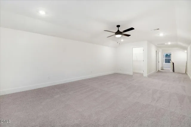 an empty room with an empty space and a ceiling fan